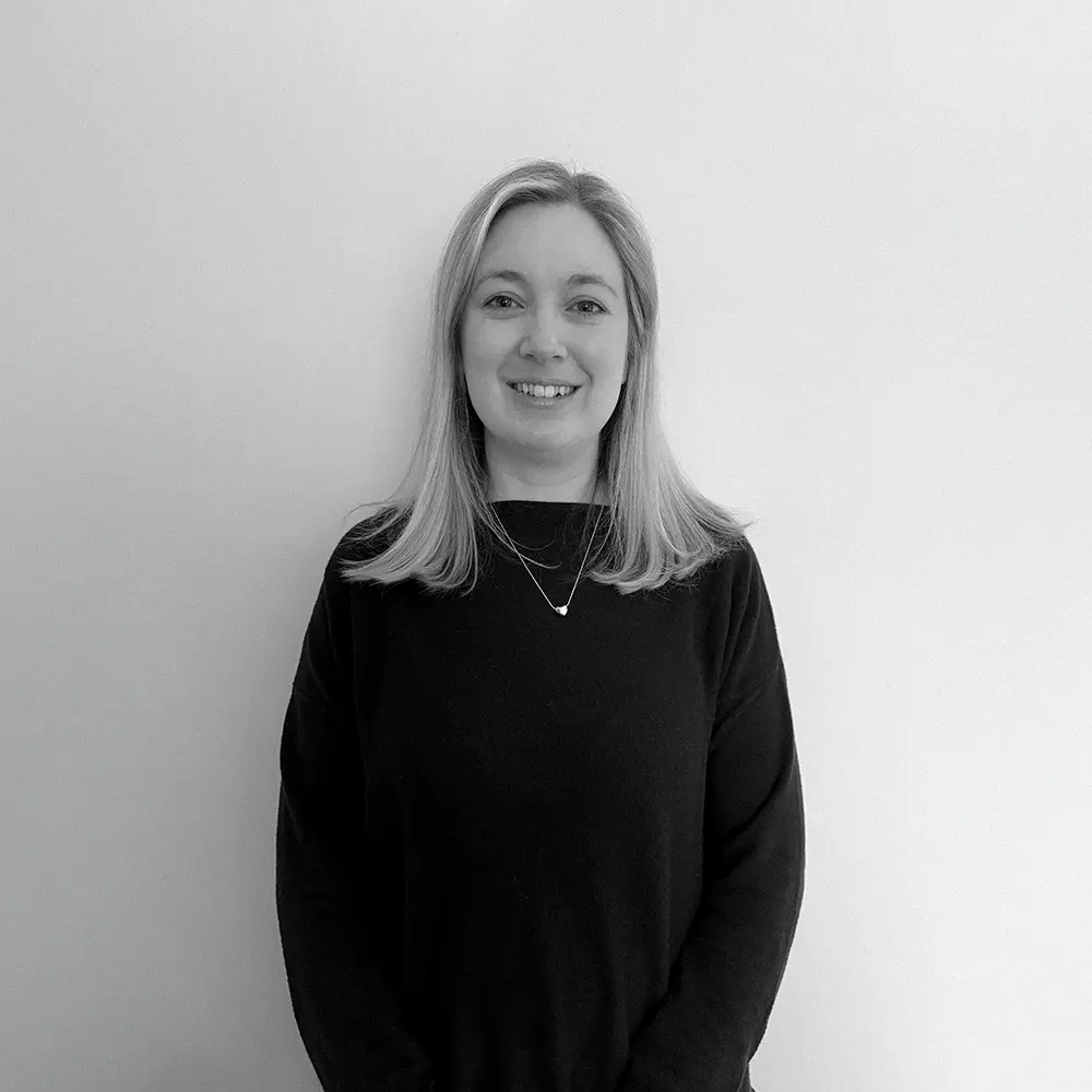 A photograph of Charlotte, from Tidal Wave, stood in front of a plain white wall.